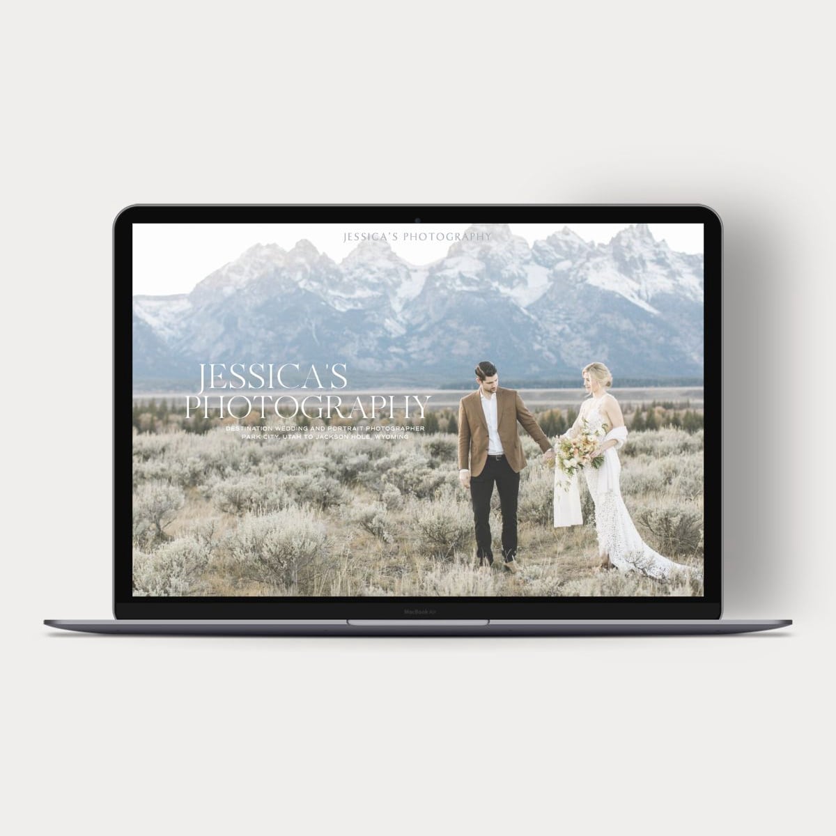 Photo of a laptop showing a new website for a wedding photographer