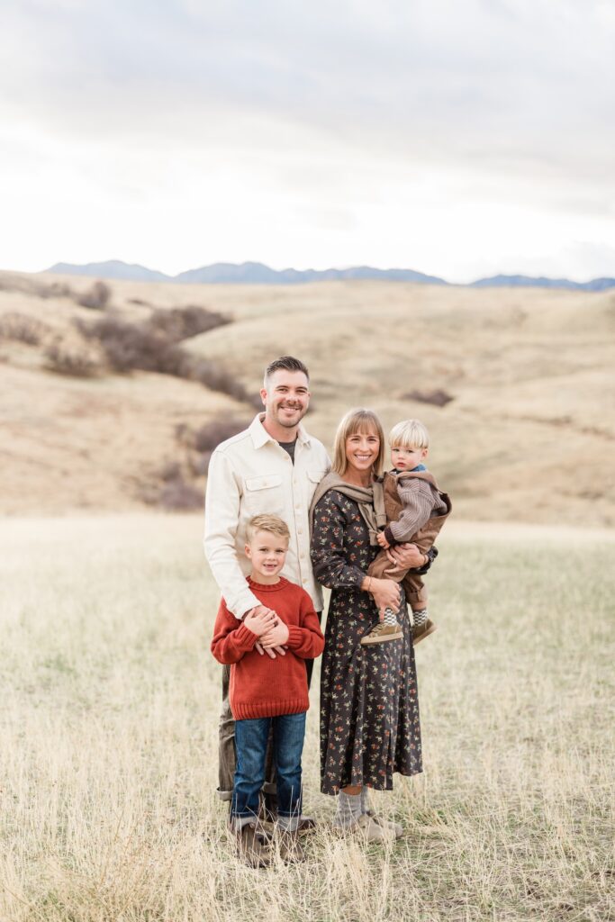Stylish family posing for family photos in beautiful November light in Cache Valley